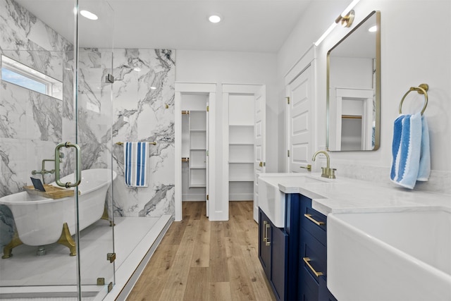 210 Galveston St, Crystal Beach, TX 77650 - full bath with a freestanding tub, a marble finish shower, vanity, wood finished floors, and recessed lighting