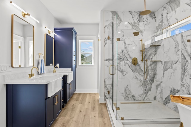 210 Galveston St, Crystal Beach, TX 77650 - full bathroom featuring a marble finish shower, healthy amount of natural light, vanity, and wood finished floors