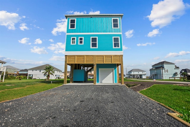 210 Galveston St, Crystal Beach, TX 77650 - coastal home featuring a residential view, a carport, driveway, and board and batten siding
