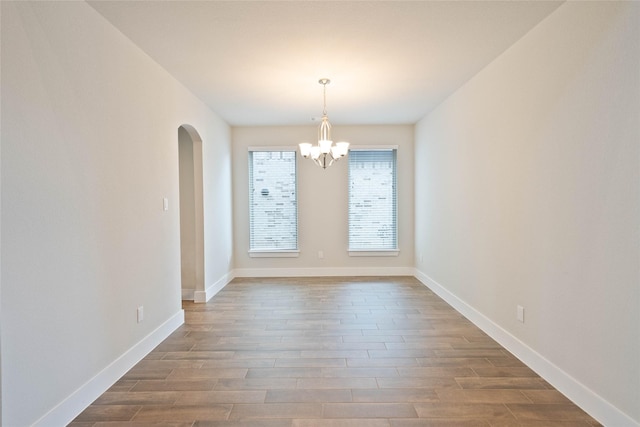 21018 Cypress Creek View Ct, Humble, TX 77338 - unfurnished dining area with a chandelier, dark wood finished floors, and arched walkways