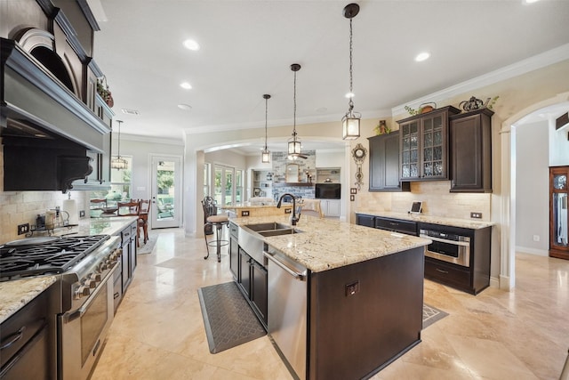 5924 Oak Leaf Ct, Conroe, TX 77304 - kitchen with stainless steel appliances, arched walkways, recessed lighting, tasteful backsplash, and glass insert cabinets