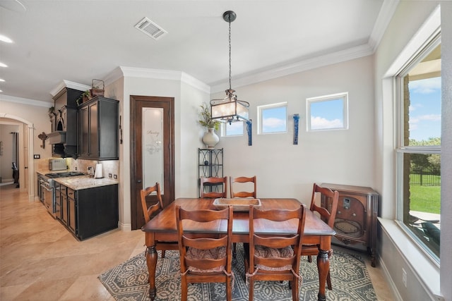 5924 Oak Leaf Ct, Conroe, TX 77304 - dining area with arched walkways, crown molding, a chandelier, and recessed lighting