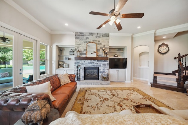 5924 Oak Leaf Ct, Conroe, TX 77304 - living room with crown molding, a ceiling fan, built in features, french doors, and arched walkways