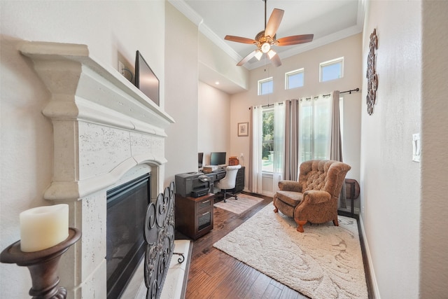 5924 Oak Leaf Ct, Conroe, TX 77304 - office space featuring ornamental molding, a glass covered fireplace, wood finished floors, and ceiling fan