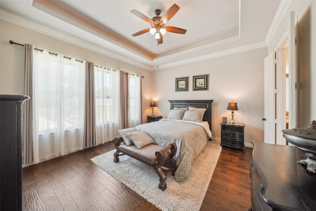 5924 Oak Leaf Ct, Conroe, TX 77304 - bedroom with a raised ceiling, dark wood-style floors, crown molding, and a ceiling fan