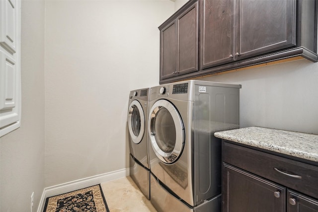 5924 Oak Leaf Ct, Conroe, TX 77304 - laundry area featuring cabinet space, washing machine and clothes dryer, and light tile patterned floors