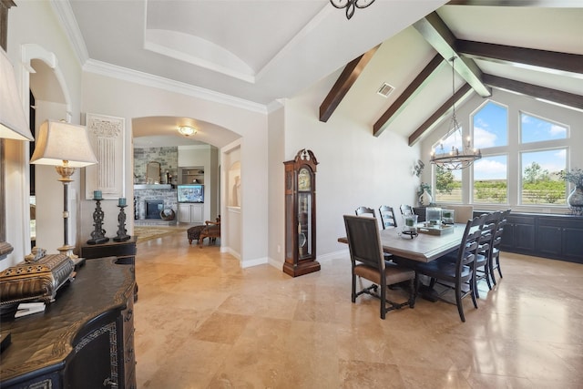 5924 Oak Leaf Ct, Conroe, TX 77304 - dining area with a chandelier, a stone fireplace, arched walkways, high vaulted ceiling, and beam ceiling