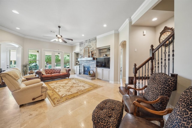 5924 Oak Leaf Ct, Conroe, TX 77304 - living area featuring arched walkways, ceiling fan, ornamental molding, recessed lighting, and a stone fireplace