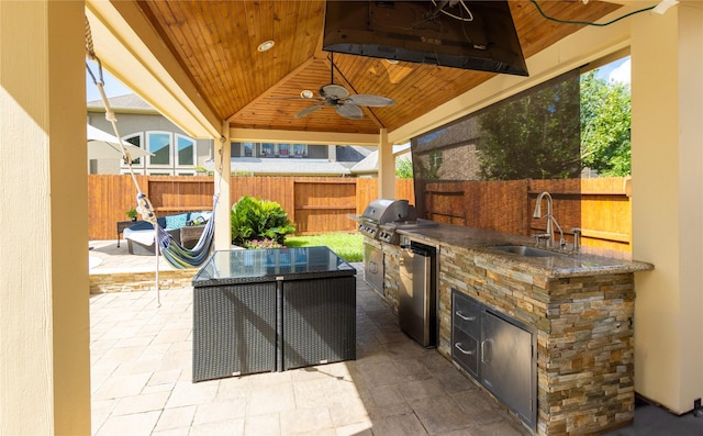 28423 Tanner Crossing Ln, Katy, TX 77494 - fenced backyard with exterior kitchen, a ceiling fan, a patio, and a gazebo