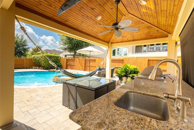 28423 Tanner Crossing Ln, Katy, TX 77494 - view of pool featuring ceiling fan, a fenced backyard, a patio, and an outdoor kitchen