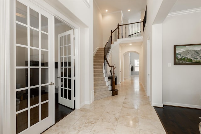 28423 Tanner Crossing Ln, Katy, TX 77494 - entrance foyer with arched walkways, french doors, stairway, crown molding, and recessed lighting