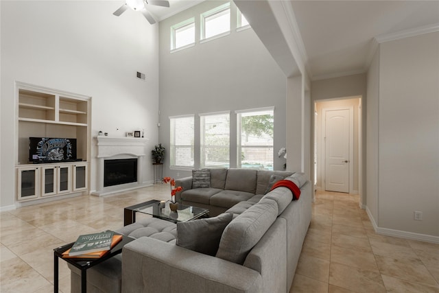 28423 Tanner Crossing Ln, Katy, TX 77494 - living room featuring ornamental molding, light tile patterned floors, a ceiling fan, built in shelves, and a fireplace with raised hearth