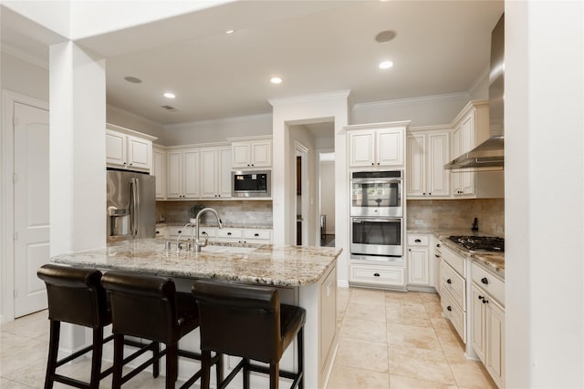 28423 Tanner Crossing Ln, Katy, TX 77494 - kitchen with appliances with stainless steel finishes, wall chimney exhaust hood, light tile patterned floors, crown molding, and a kitchen bar