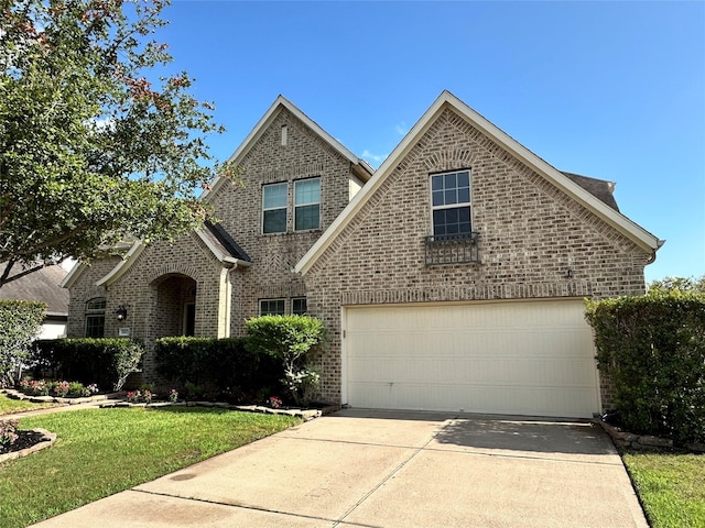28423 Tanner Crossing Ln, Katy, TX 77494 - traditional-style home with brick siding, concrete driveway, and a front yard