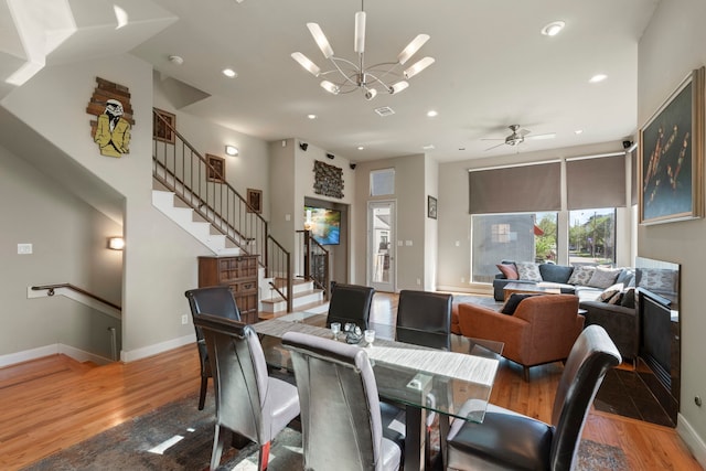 5122 Lillian St, Houston, TX 77007 - dining area featuring light wood-style floors, recessed lighting, a chandelier, stairs, and a ceiling fan