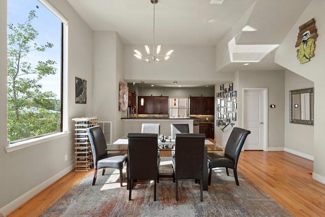 5122 Lillian St, Houston, TX 77007 - dining area with a chandelier and light wood-style flooring