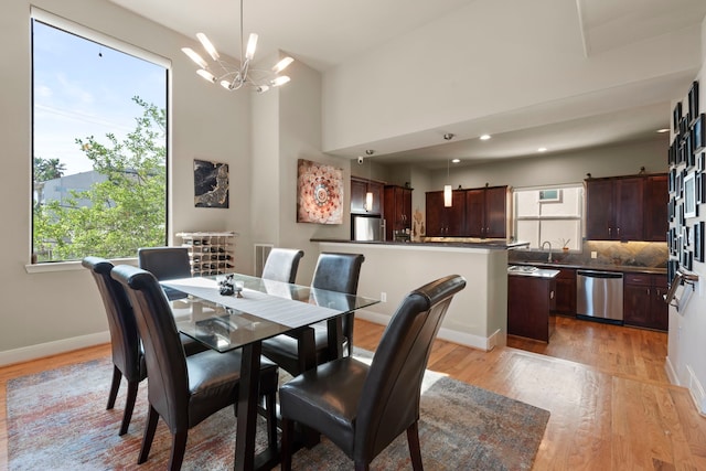 5122 Lillian St, Houston, TX 77007 - dining area featuring light wood-type flooring, a chandelier, and recessed lighting