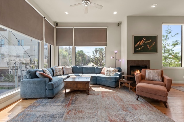 5122 Lillian St, Houston, TX 77007 - living area with wood finished floors, a lit fireplace, a ceiling fan, and recessed lighting