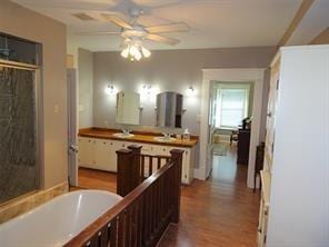 1401 Truxillo St, Houston, TX 77004 - bathroom with a bathtub, ceiling fan, wood finished floors, and a shower stall