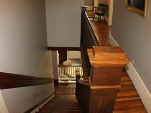1401 Truxillo St, Houston, TX 77004 - stairway with baseboards and wood finished floors