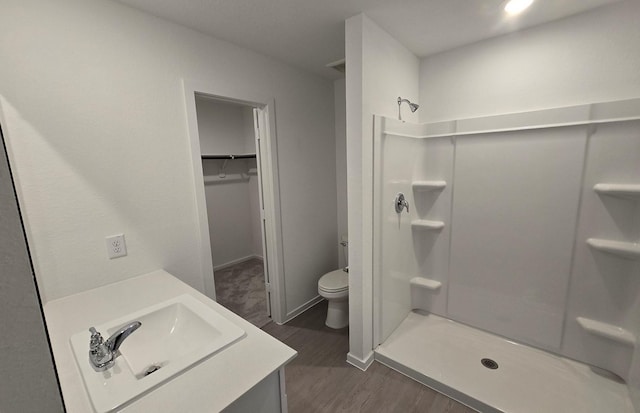 3005 Blue Gem Ct, Katy, TX 77493 - bathroom with wood finished floors, vanity, a shower stall, and a spacious closet