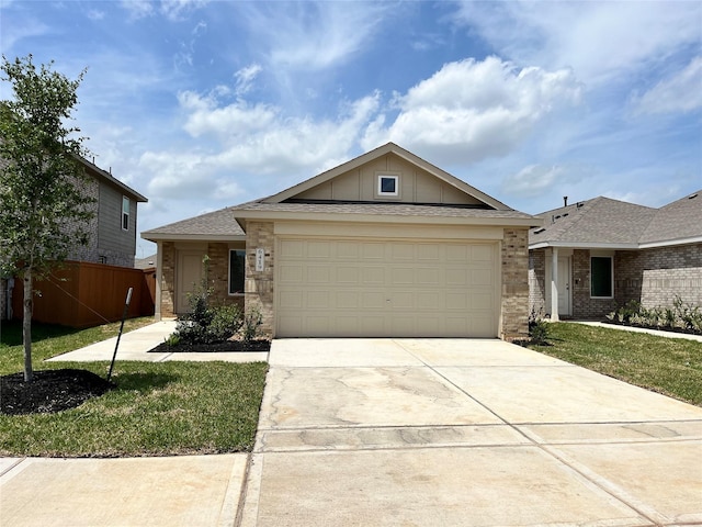 3005 Blue Gem Ct, Katy, TX 77493 - ranch-style house featuring a garage, concrete driveway, brick siding, a front lawn, and board and batten siding