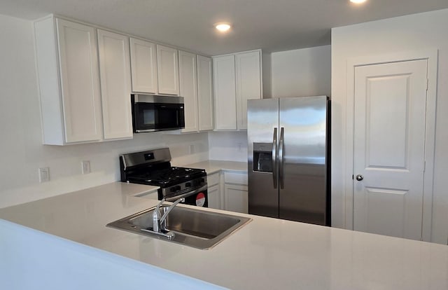 3005 Blue Gem Ct, Katy, TX 77493 - kitchen featuring appliances with stainless steel finishes, light countertops, recessed lighting, and white cabinets