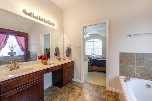 24514 Hikers Bend Dr, Katy, TX 77493 - ensuite bathroom featuring double vanity, a garden tub, stone finish flooring, and a ceiling fan
