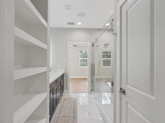 825 Paul Quinn St Unit E, Houston, TX 77091 - bathroom with a stall shower, double vanity, marble finish flooring, and recessed lighting