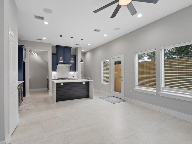 825 Paul Quinn St Unit E, Houston, TX 77091 - kitchen with ceiling fan, light countertops, blue cabinetry, a kitchen island with sink, and decorative light fixtures