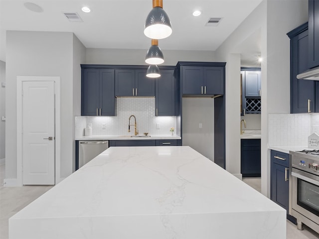 825 Paul Quinn St Unit E, Houston, TX 77091 - kitchen featuring stainless steel appliances, backsplash, light stone counters, a kitchen island, and hanging light fixtures