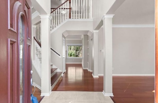 9110 Memorial Creek Dr, Spring, TX 77379 - entrance foyer with stairway, a high ceiling, wood finished floors, and decorative columns