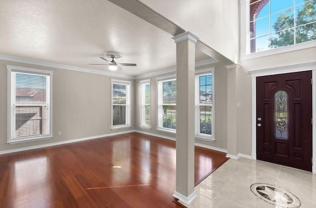 9110 Memorial Creek Dr, Spring, TX 77379 - entryway featuring plenty of natural light, ornamental molding, a ceiling fan, wood finished floors, and ornate columns
