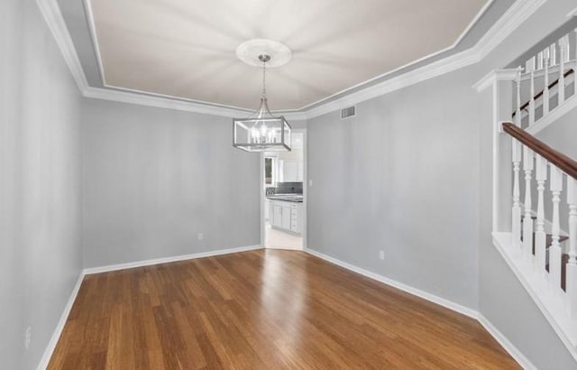 9110 Memorial Creek Dr, Spring, TX 77379 - unfurnished dining area with wood finished floors, stairway, a chandelier, and crown molding