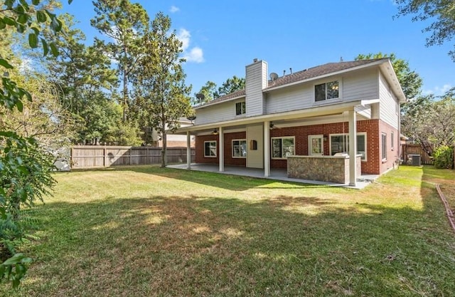 9110 Memorial Creek Dr, Spring, TX 77379 - rear view of property with brick siding, a chimney, a fenced backyard, and a patio