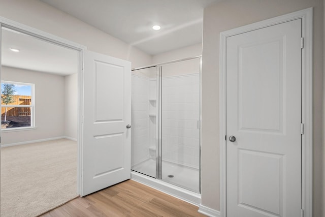 10391 Red Cardinal Dr, Cleveland, TX 77328 - bathroom featuring a stall shower and wood finished floors