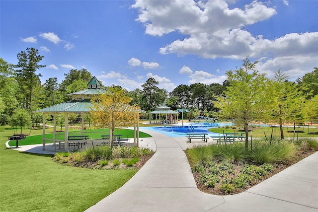 10391 Red Cardinal Dr, Cleveland, TX 77328 - view of community with a gazebo, a yard, and a pool