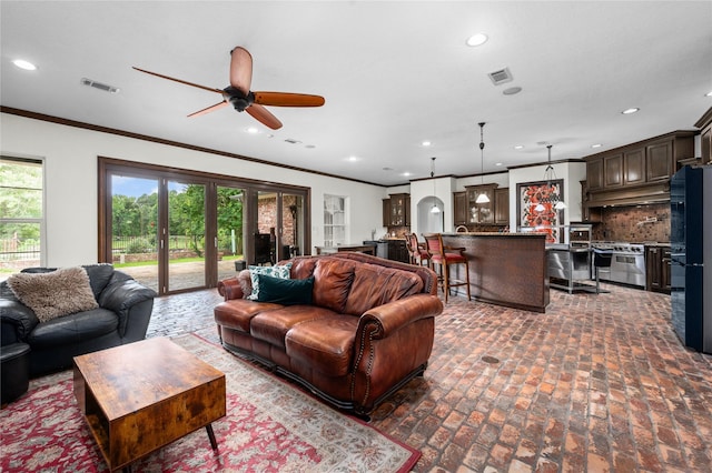 2790 Derby Ln, Madisonville, TX 77864 - living room featuring brick floors, a ceiling fan, ornamental molding, recessed lighting, and french doors