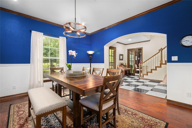 2790 Derby Ln, Madisonville, TX 77864 - dining room featuring arched walkways, a wainscoted wall, ornamental molding, a chandelier, and hardwood / wood-style flooring