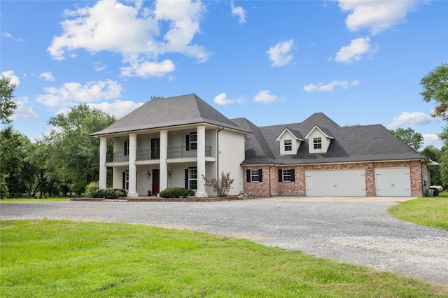 2790 Derby Ln, Madisonville, TX 77864 - neoclassical / greek revival house with curved driveway, a front yard, a balcony, brick siding, and a garage