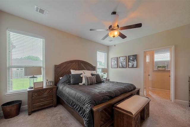9119 Anna St, Needville, TX 77461 - bedroom with light colored carpet, a ceiling fan, and ensuite bathroom