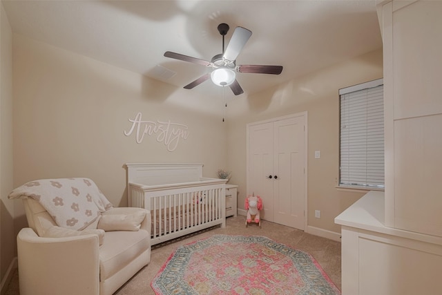 9119 Anna St, Needville, TX 77461 - bedroom featuring light colored carpet, ceiling fan, a nursery area, and a closet