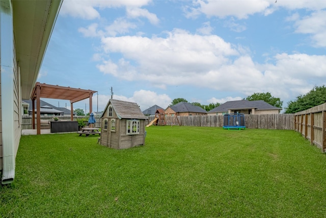 9119 Anna St, Needville, TX 77461 - fenced backyard featuring a playground and a trampoline