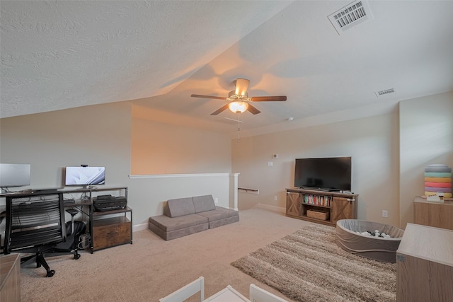 9119 Anna St, Needville, TX 77461 - carpeted living area with an office area, ceiling fan, lofted ceiling, and a textured ceiling