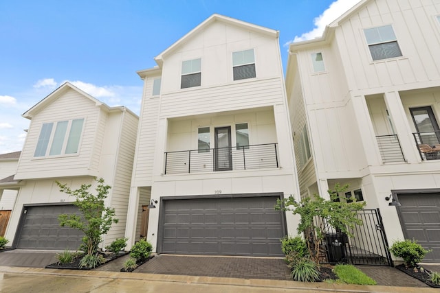 709 Sienna Palm Ln, Houston, TX 77008 - townhome / multi-family property with a garage, a gate, a balcony, board and batten siding, and driveway