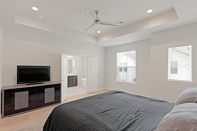 709 Sienna Palm Ln, Houston, TX 77008 - bedroom with a tray ceiling, light wood-style flooring, recessed lighting, a ceiling fan, and ensuite bath