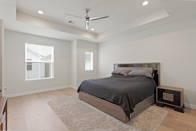709 Sienna Palm Ln, Houston, TX 77008 - bedroom with a tray ceiling, light wood-style floors, recessed lighting, and ceiling fan