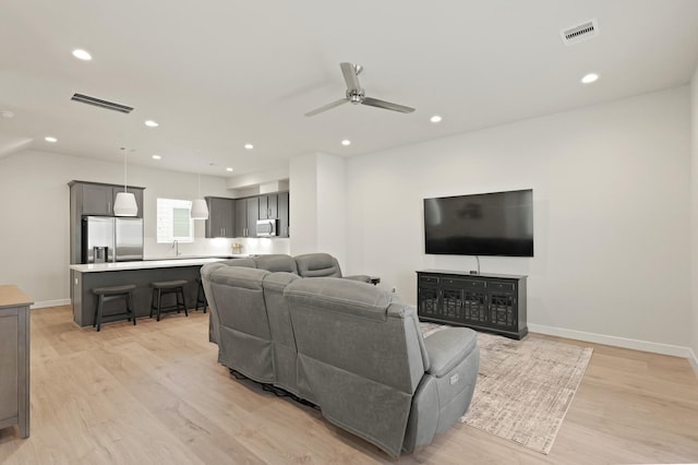 709 Sienna Palm Ln, Houston, TX 77008 - living room with light wood finished floors, ceiling fan, and recessed lighting