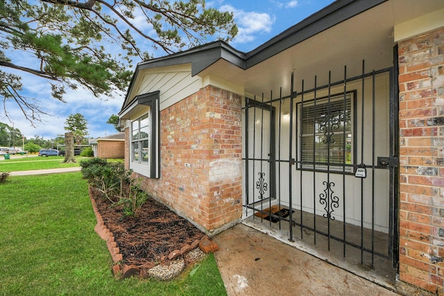9611 Bertwood St, Houston, TX 77016 - entrance to property featuring brick siding, a yard, and covered porch
