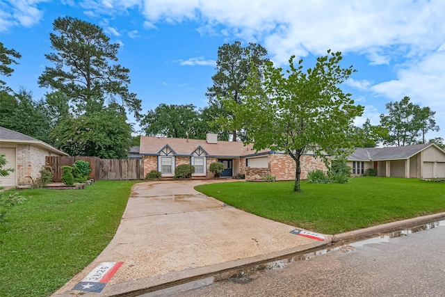 3626 Wells Mark Dr, Humble, TX 77396 - view of front of house featuring driveway, brick siding, and a chimney